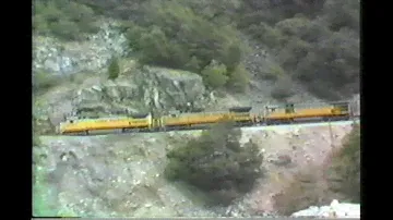 1054.  3  UNION PACIFIC UP 9107 stack train in the feather river canyon from across river in March 1